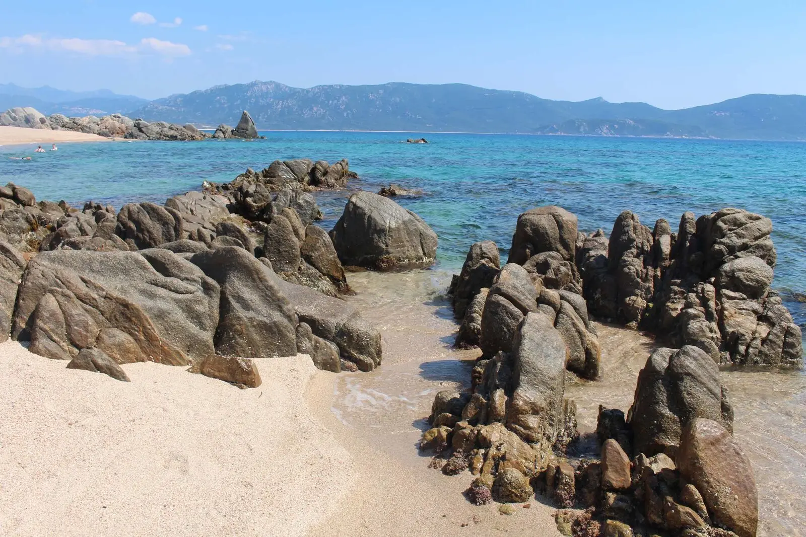 Granite rocks and clear water on the beach in front of the hotel