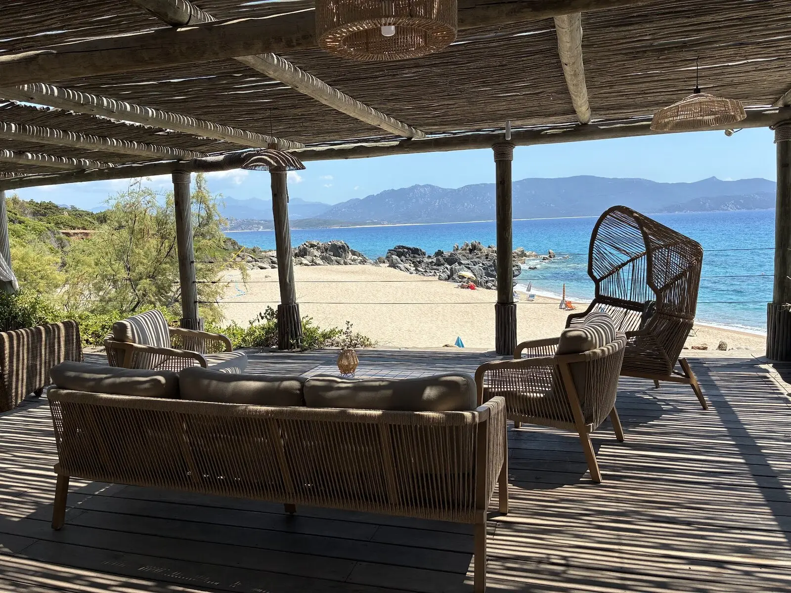 The shaded beachfront lounge deck facing the bay