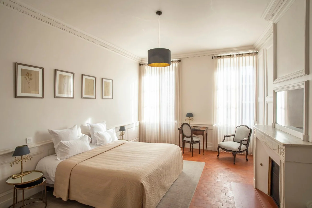 Elegant hotel suite with terracotta floors and antique furnishings