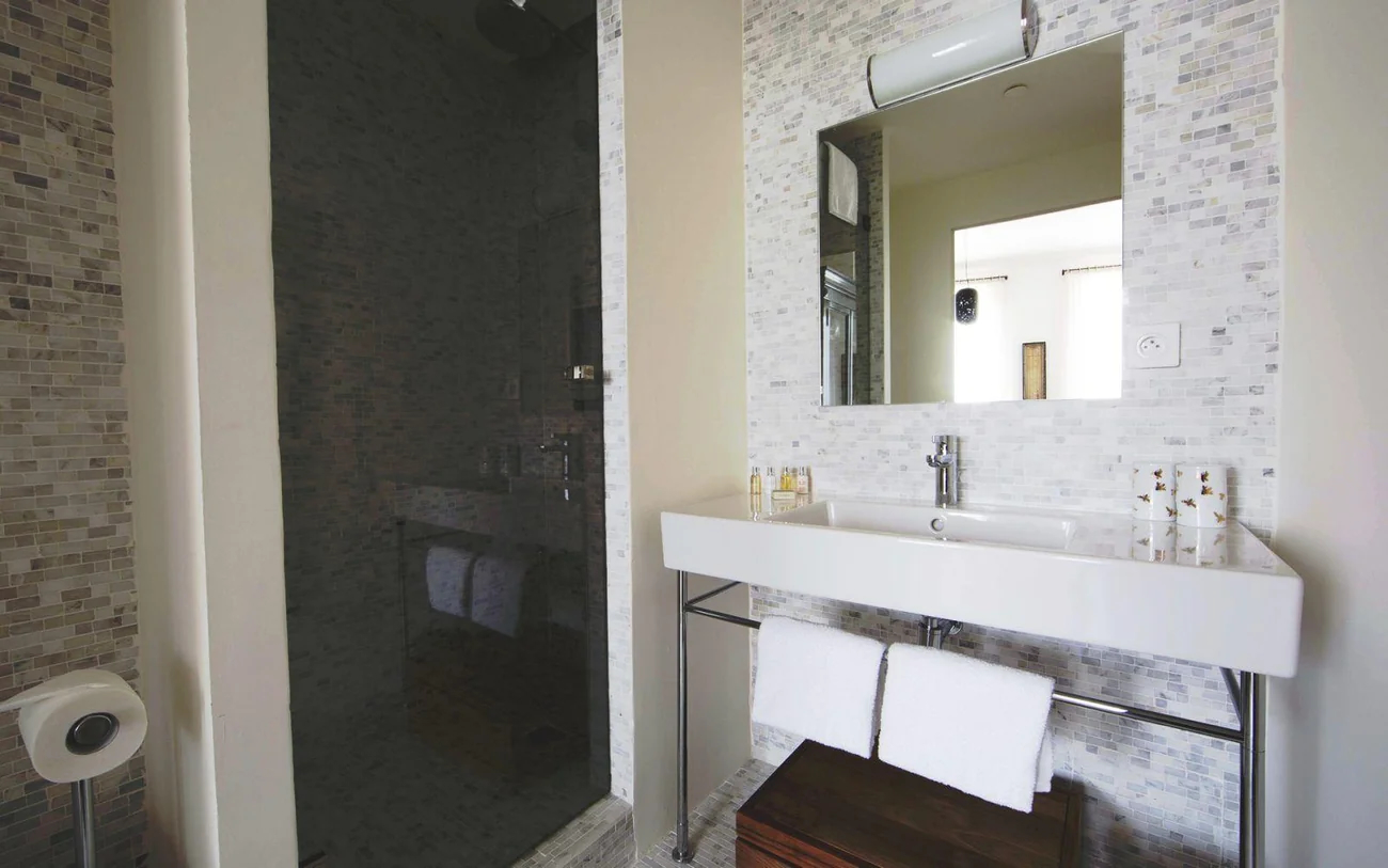 Modern en-suite bathroom with mosaic tiles and walk-in shower