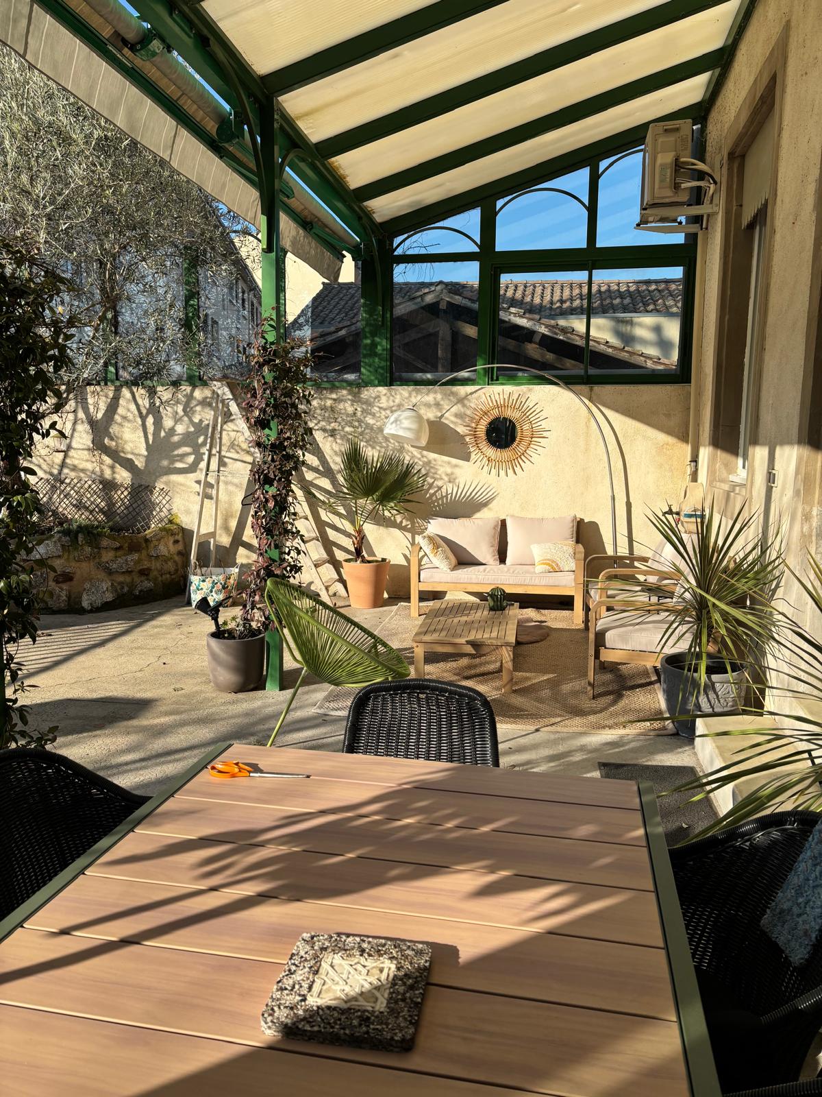 Covered terrace with seating area and river views