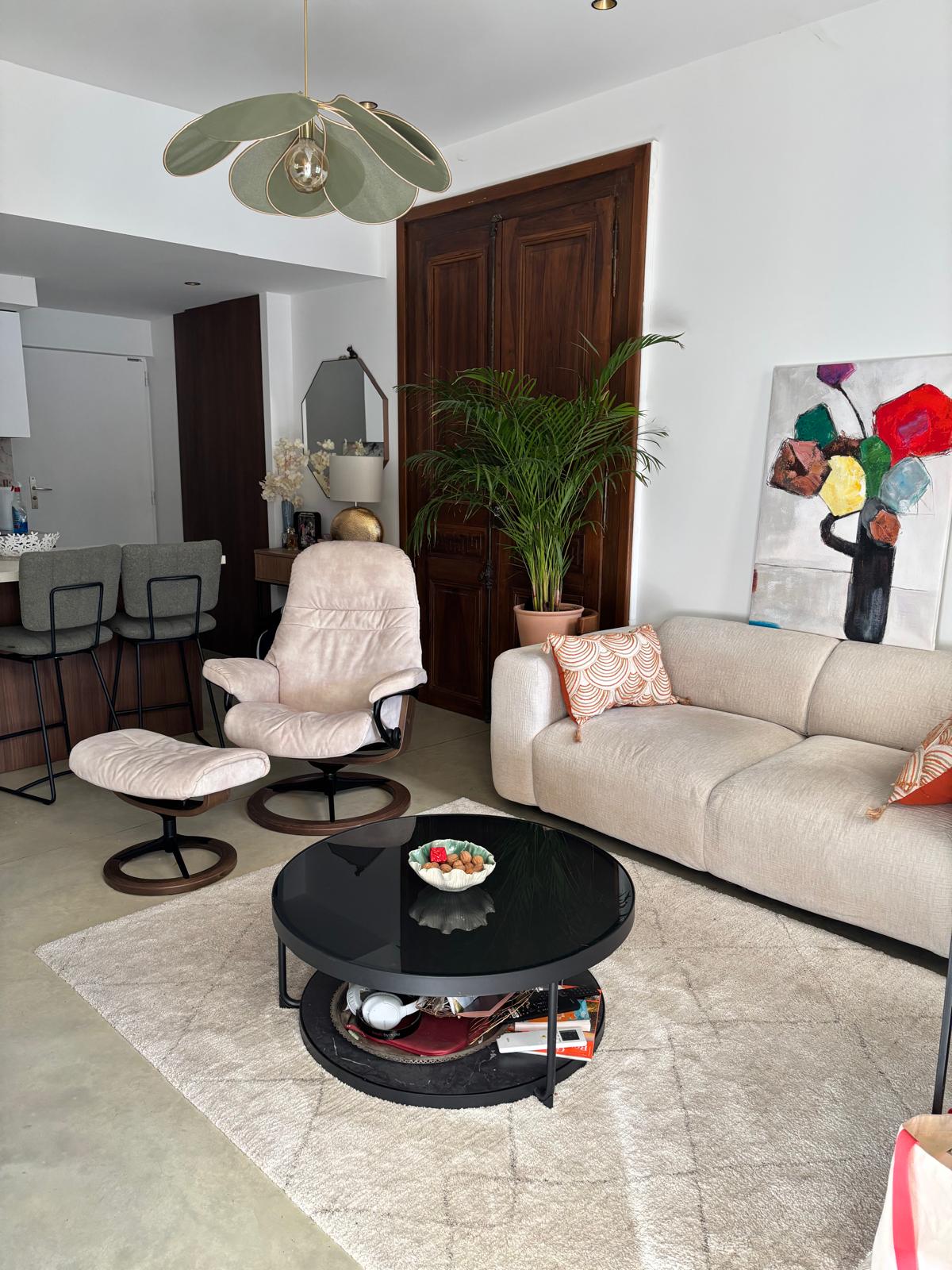 Bright living area with sofa, artwork, and open-plan layout